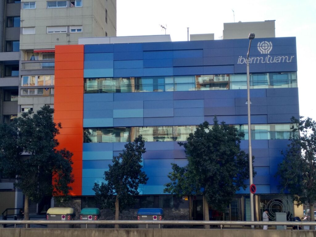 a blue and orange building with trees in front of it